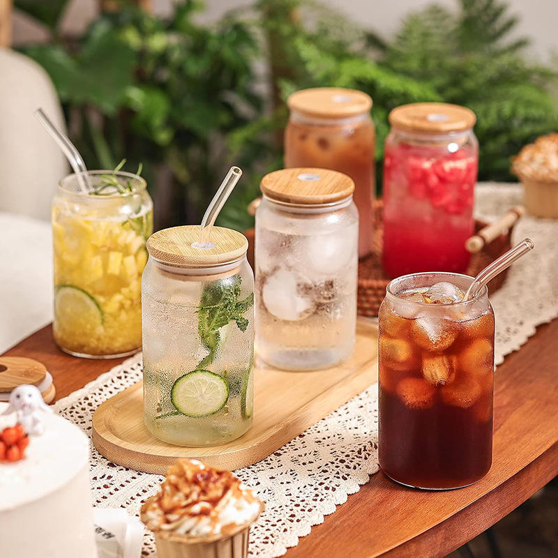Assorted beverages in jars with wooden lids on a table with a lace tablecloth.