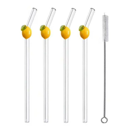 Four clear glass drinking straws with yellow and green lemon designs on the upper portion, shown alongside one metal cleaning brush on a white background, with text reading '4Pcs+1Cleaning Brush'.
